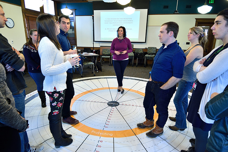 Jessica speaking to a group in a circle
