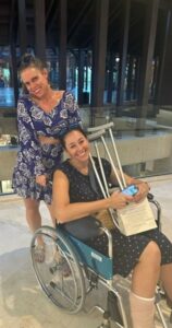 Jessica in a wheelchair with a broken ankle.